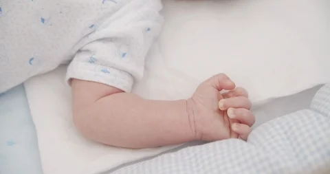 Newborn baby hand in cot Stock Footage 112372183