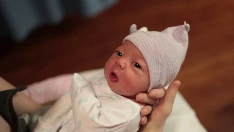 Newborn Baby in Hat Looking at Camera Stock Footage 85333229