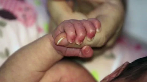 Newborn Baby Holding Her Mother's Finger Stock Footage