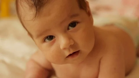 A newborn baby lies on the stomach Stock Footage