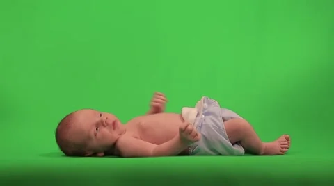 Newborn baby lying and pulling the handles on the background. Stock Footage 50254938