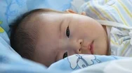 Newborn Baby Lying And Relaxing On The Bed. Healthy Children Concept. Stock Footage