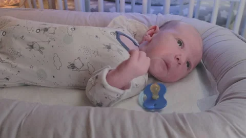A newborn baby, one month old, pulls Stock Video Pond5