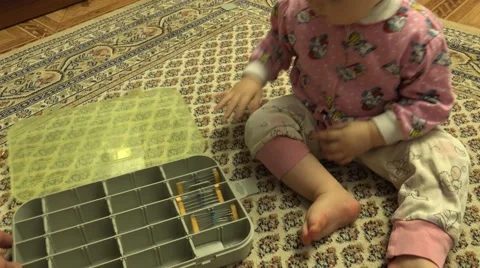 Newborn Baby Playing with Plastic Case with Hardware Items. Closeup. 4K UltraHD, Stockbeeldmateriaal 61103984