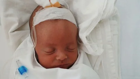 Newborn baby sleeping on a drip in a hospital Stock Footage