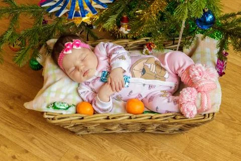 Newborn baby sleeps in a basket Stock Photos