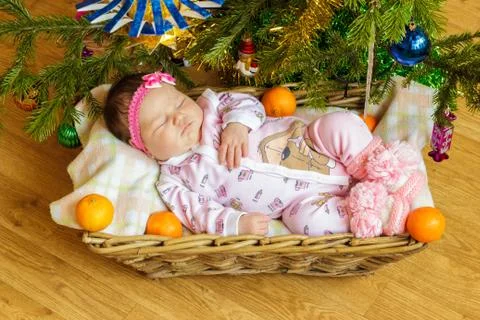 Newborn baby sleeps in a basket Stock Photos