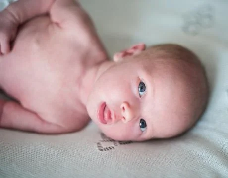 Newborn baby smiling looking at the camera Stock Photos