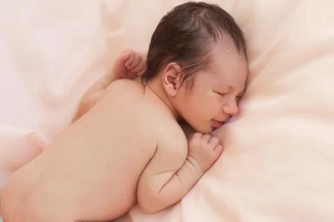 Newborn on beige background Stock Photos