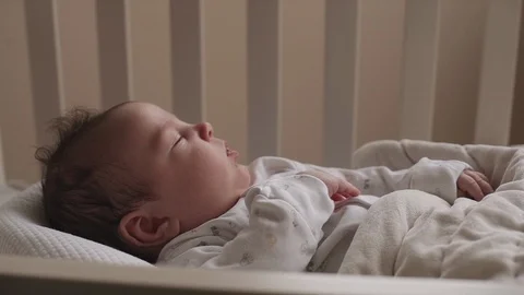 Newborn boy lies on the bed Stock Footage 87206077