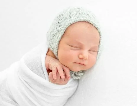 Newborn boy wrapped in a blanket Stock Photos