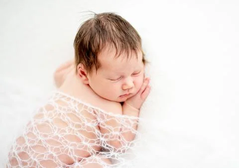 Newborn covered with blanket Stock Photos