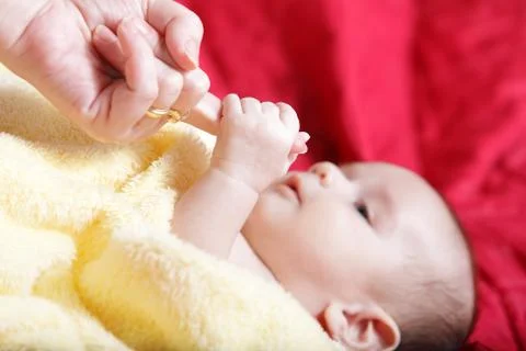 Newborn - first touches with mother hand Stock Photos