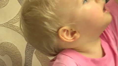 Newborn Girl Using Tablet Computer while Sitting on CouchHD. 4K UltraHD, UHD Stock Footage 82461904