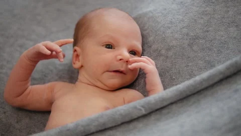 A newborn on a gray background. The first days of life Stock Footage 133000048