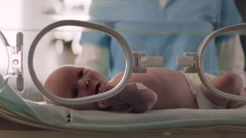 Newborn inside a Crib in the Hospital looking around Stock Footage 283071120
