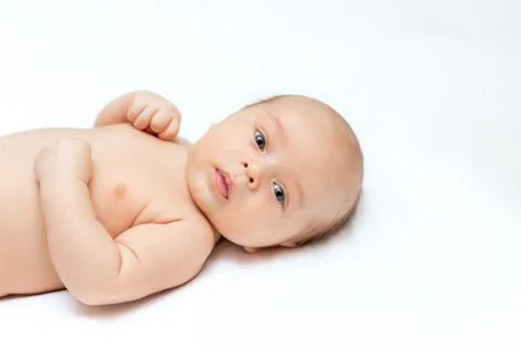 Newborn is lying on a white blanket Stock Photos