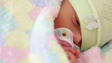 Newborn with pacifier in bed Stock Footage 91864856
