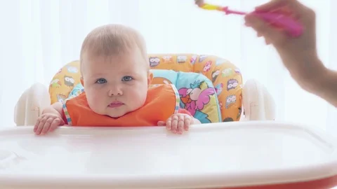 The newborn with pleasure eats food with a spoon Stock Footage 72548258