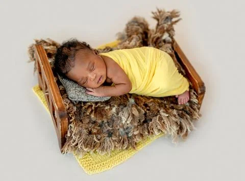 Newborn sleeping in cradle Stock Photos