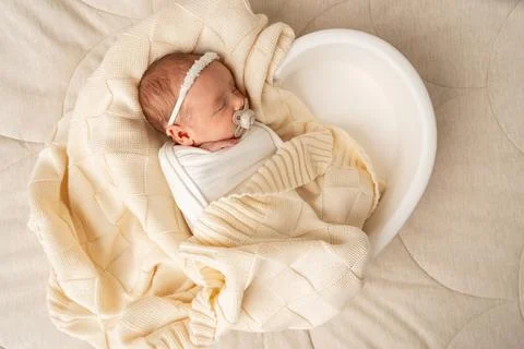 Newborn sleeping in soft neutral setting Фото