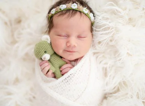 Newborn smiling in dream Stock Photos
