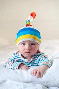 Newborn in a striped hat Stock Photos