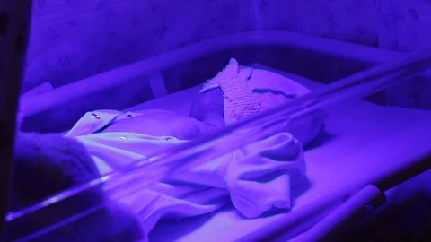 Newborn under ultraviolet lamp Stock Footage 103174128