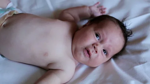 Newborn was smiling when it watching somethink Stock Footage 61498422