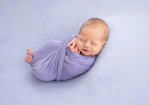 Newborn wrapped in blanket Stock Photos