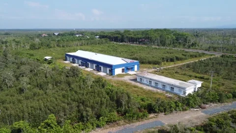 This newly completed blue warehouse is located in a quiet area, full of trees Stock Footage 319970307