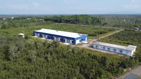 This newly completed blue warehouse is located in a quiet area, full of trees Stock Footage 319970408