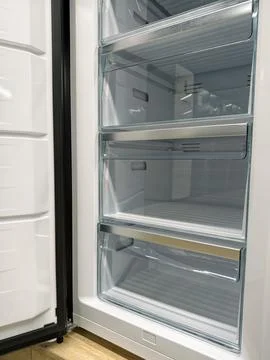 Newly designed fridge with open door, now for sale in a home electronics stor Stock Photos