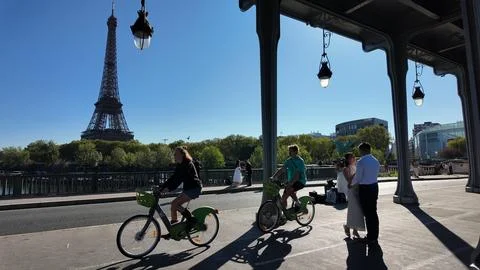 Newly engaged couple with the Eiffel Tower of Paris behind them Stock Photos