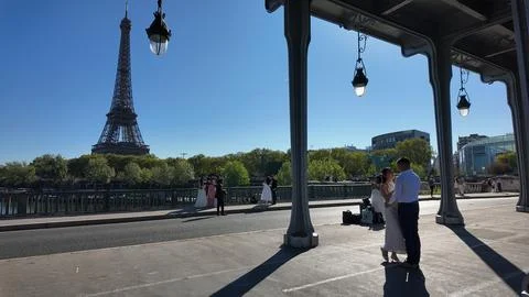 Newly engaged couple with the Eiffel Tower of Paris behind them Stock Photos