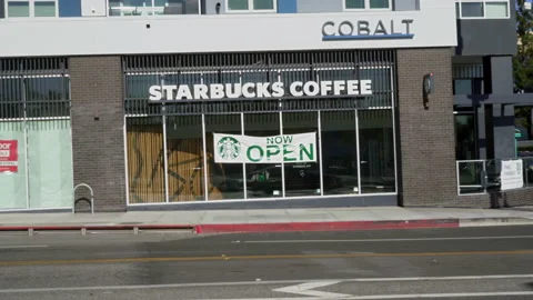 A Newly Opened Starbucks Store With A "Now Open" Sign Stock Footage 149892659
