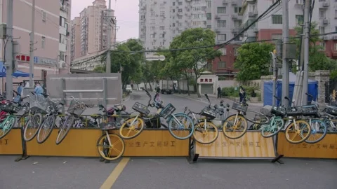 Newly Released People Marvel at Makeshift Barrier Made of Bicycles in Shanghai Stock Footage 194808441