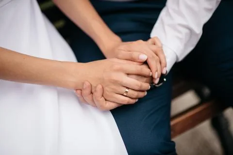 Newly wed couple's hands with wedding rings Stock Photos
