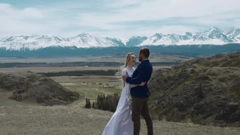 A newlywed standing on a mountain top. Stock Footage 318569656