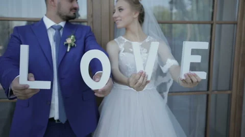 Newlyweds are holding the letter in his hands on a photo shoot Stock Footage