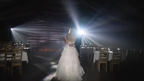 Newlyweds first dance at rustic wedding reception with atmospheric lighting Stock Footage 299940427