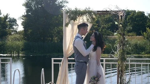 Newlyweds hugging on the background of the arch Stock Footage 106349682