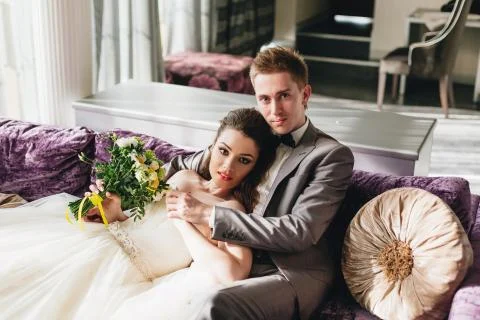 Newlyweds lying on the sofa Stock Photos