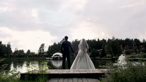 Newlyweds on the pier in backlight Stock Footage 137802419
