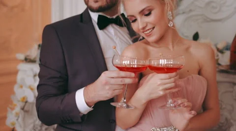 Newlyweds pose for the camera while holding the glasses in hand Stock Footage 61052250
