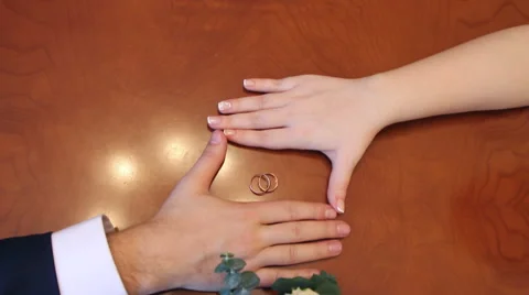 Newlyweds rings on the table Stock Footage 61147922