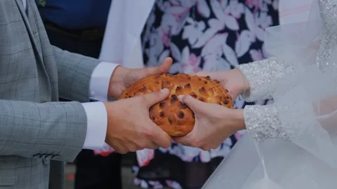 Newlyweds share wedding bread, wedding traditions Stock Footage 306156903