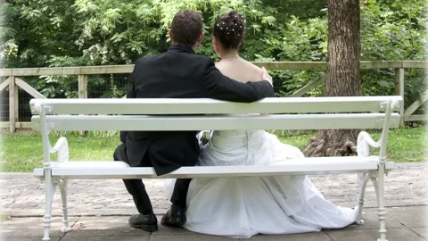 Newlyweds sitting on a bench Stock Footage 145685369