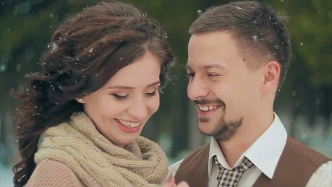 Newlyweds smiling during snowfall on Winter Day. Stock Footage 80973728