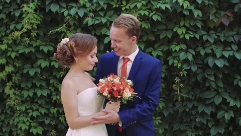 Newlyweds Stand on Background of Deciduous Wall Slow Motion Stock Footage 75004600